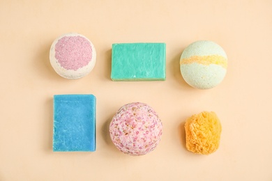 Photo of Flat lay composition with bath bombs and soap bars on color background