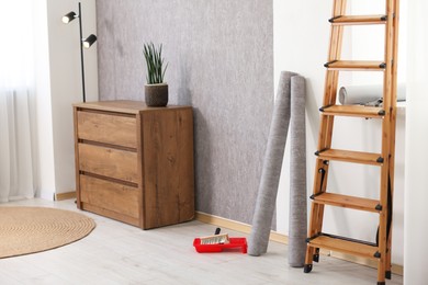 Photo of Home renovation. Room interior with stylish gray wallpaper on wall