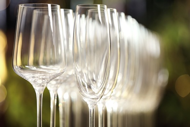 Photo of Set of empty glasses on blurred background, closeup