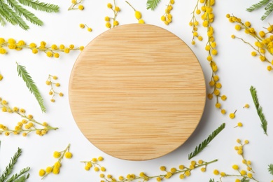 Photo of Beautiful mimosa flowers and wooden board on white background, flat lay. Space for text