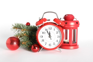 Photo of Alarm clock with Christmas decor on white background. New Year countdown