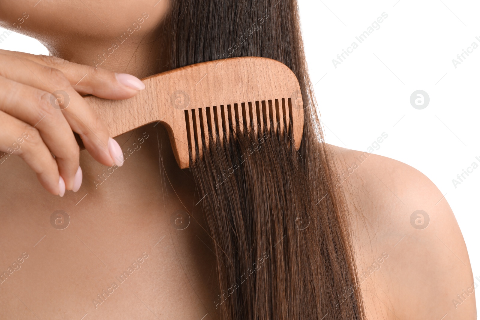 Photo of Young woman with wooden hair comb on white background, closeup