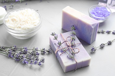 Handmade soap bars with lavender flowers on grey stone table