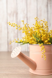 Bouquet of beautiful mimosa flowers on wooden table