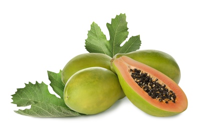 Fresh ripe papaya fruits and green leaves on white background