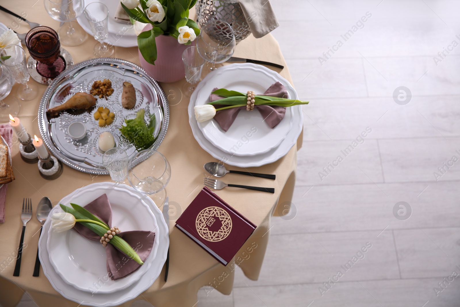 Photo of Festive Passover table setting with Torah, top view. Pesach celebration