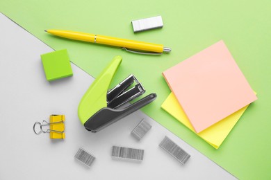 Photo of Flat lay composition with new stapler on color background