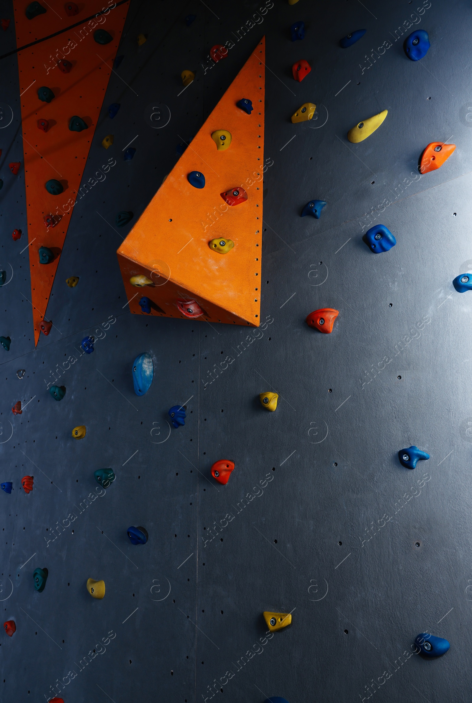 Photo of Climbing wall with holds in gym. Extreme sport