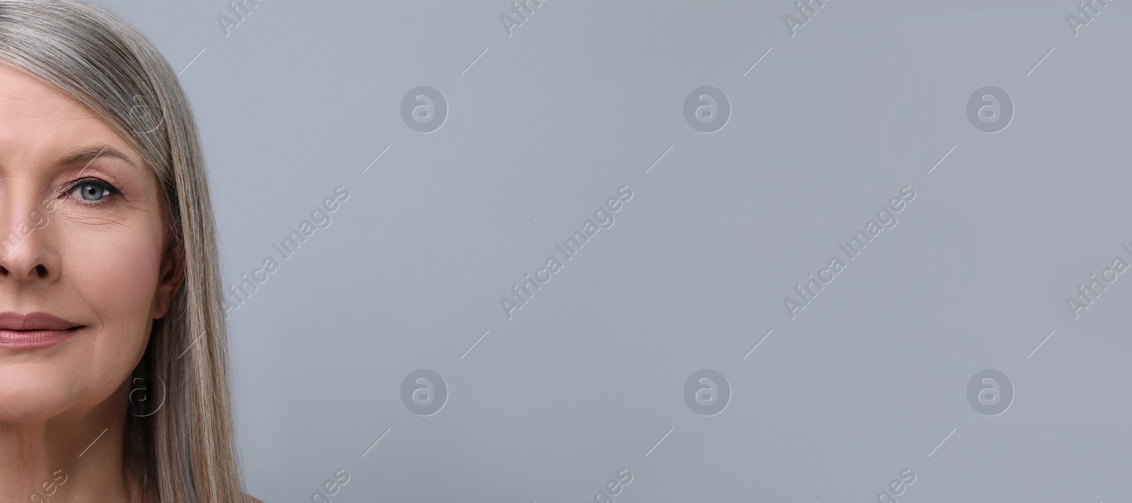 Image of Portrait of beautiful mature woman on light grey background. Banner design with space for text