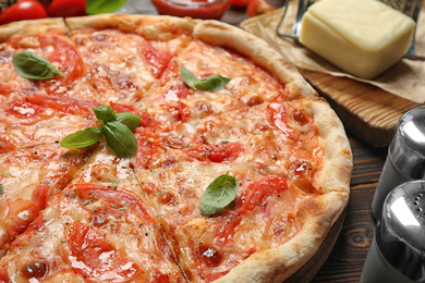Delicious pizza Margherita on wooden table, closeup view