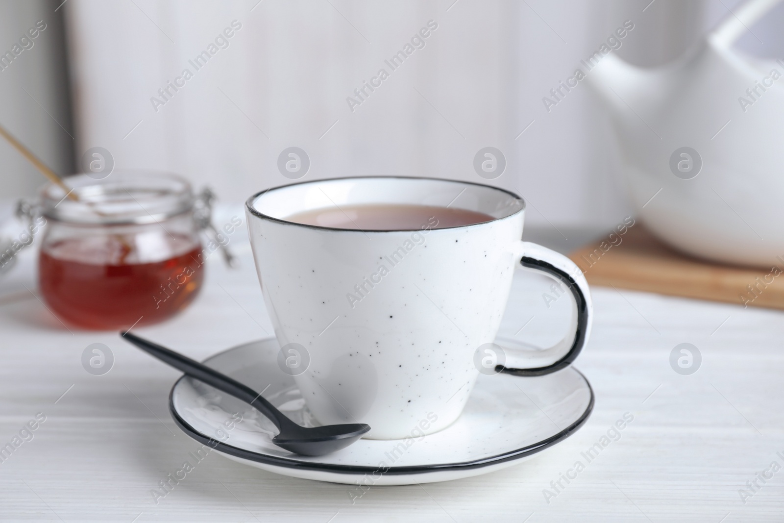Photo of Cup of fresh tasty tea on white table