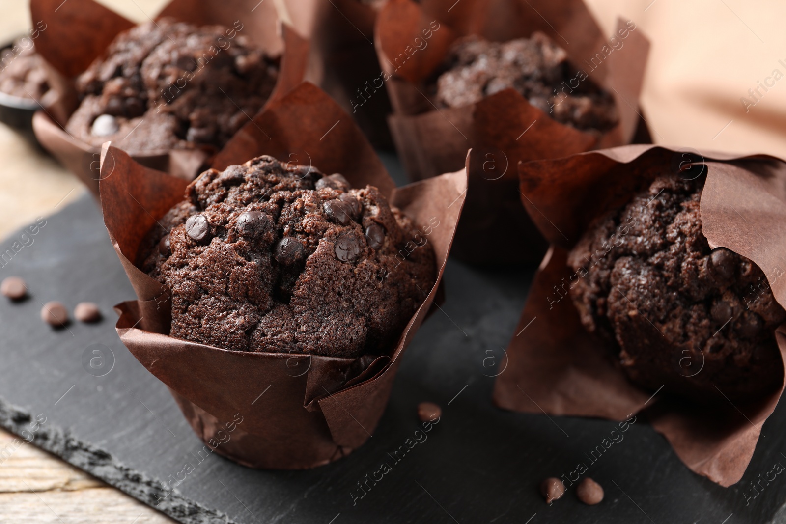 Photo of Delicious chocolate muffins on table, closeup view