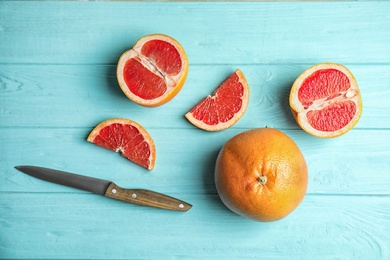 Photo of Flat lay composition with grapefruits on color background