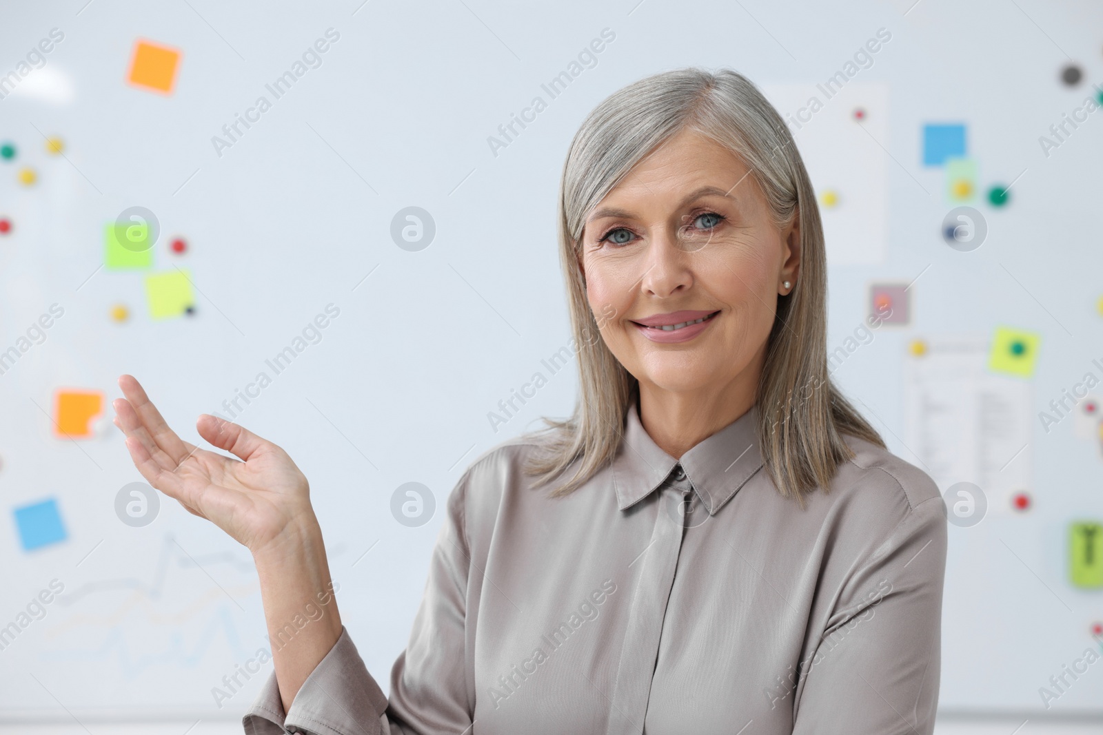 Photo of Portrait of happy professor near whiteboard. Space for text