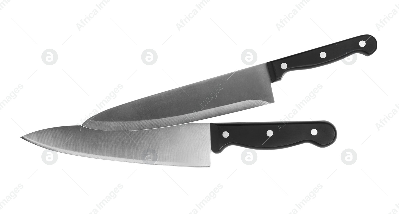 Photo of Stainless steel chef's knives on white background, top view