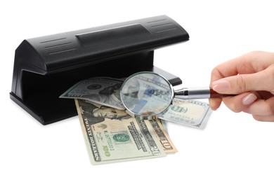 Photo of Woman checking dollar banknotes with currency detector and magnifying glass on white background, closeup. Money examination device