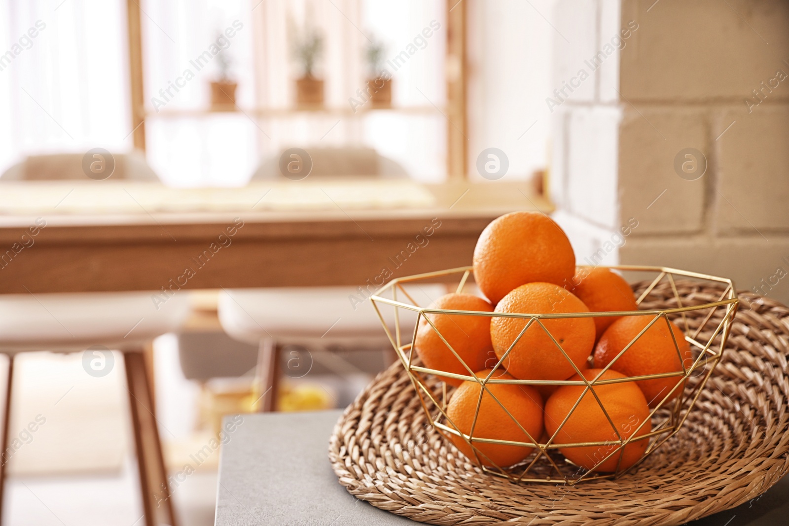 Photo of Fresh ripe oranges on countertop in kitchen. Space for text