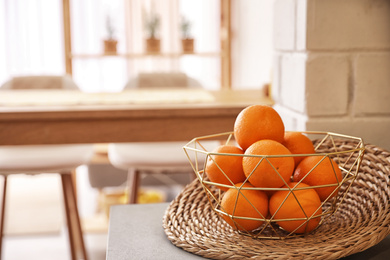 Fresh ripe oranges on countertop in kitchen. Space for text