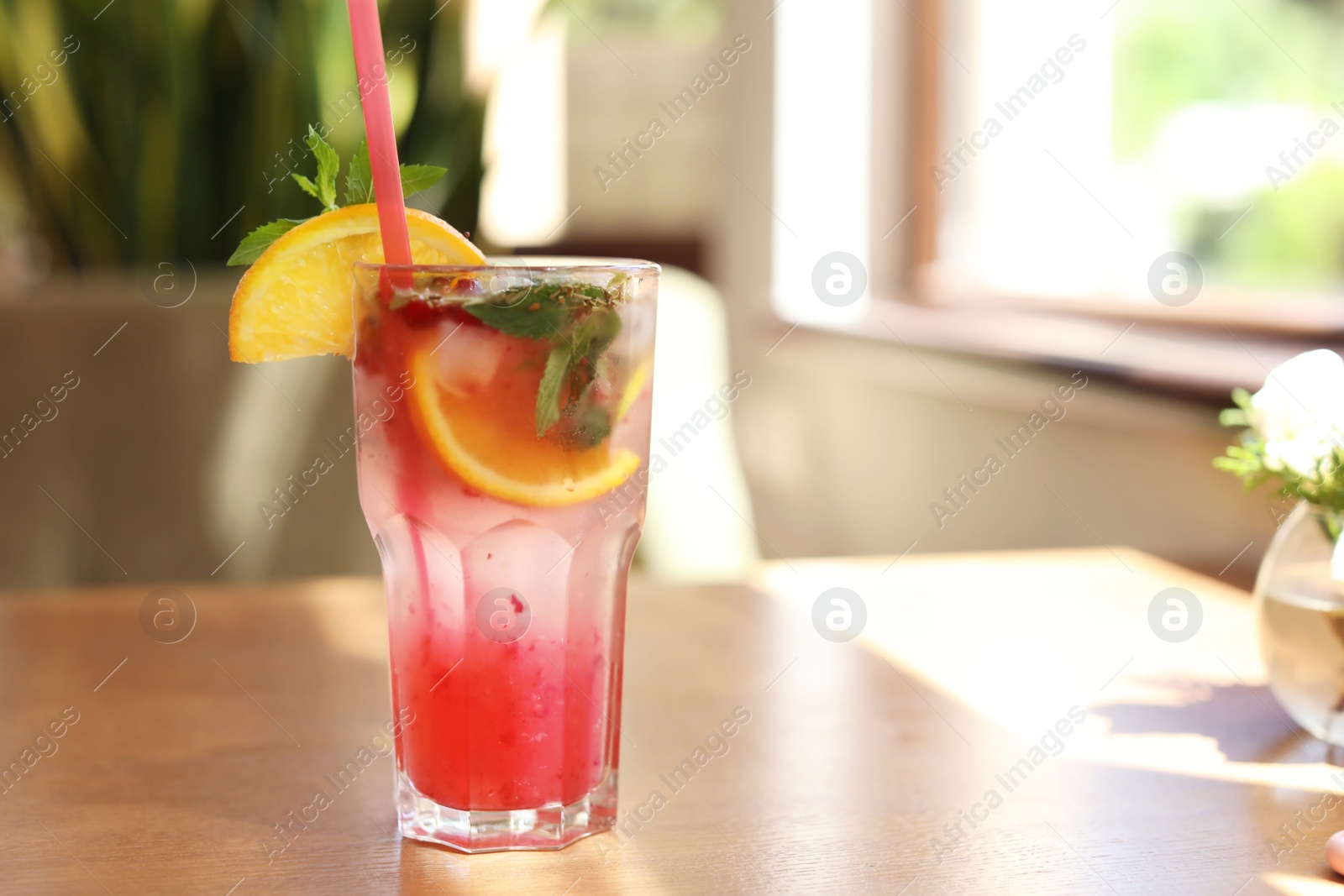 Photo of Refreshing natural lemonade with mint and orange in glass on table. Detox drink