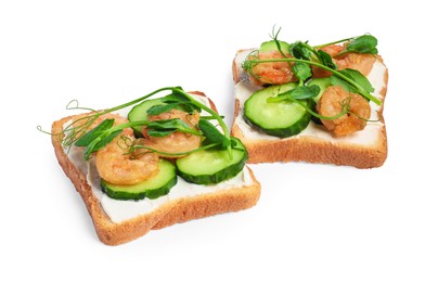 Photo of Tasty toasts with cream cheese, shrimps, cucumbers and microgreens on white background