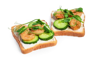 Tasty toasts with cream cheese, shrimps, cucumbers and microgreens on white background