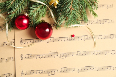 Flat lay composition with Christmas decorations on music sheets