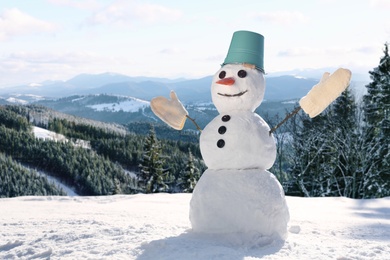 Image of Funny snowman outdoors on sunny day, space for text