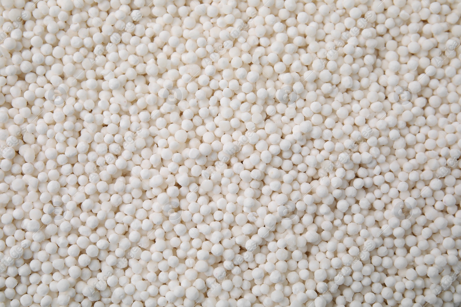 Photo of White tapioca pearls as background, top view