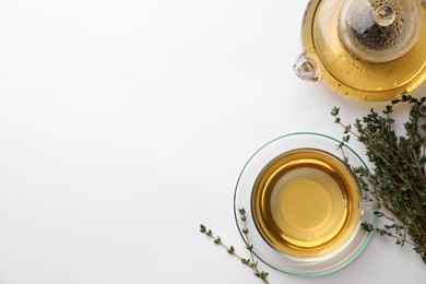 Photo of Aromatic herbal tea with thyme on white table, flat lay. Space for text