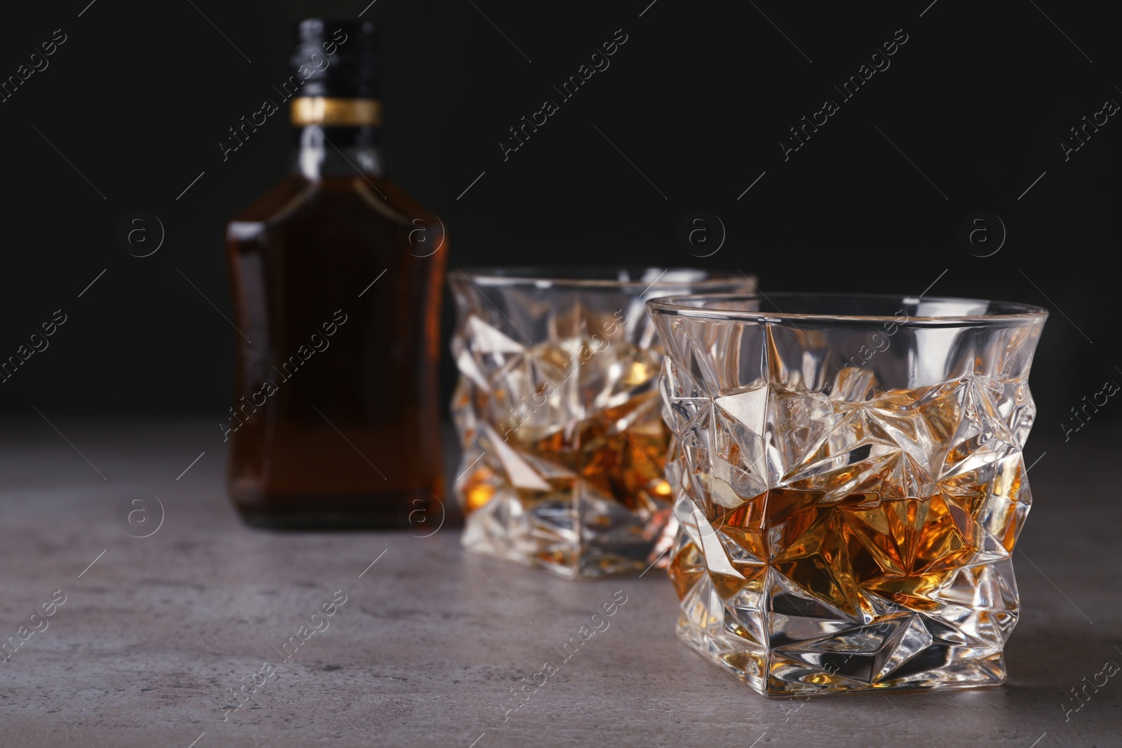 Photo of Composition with glass of whiskey on table. Space for text