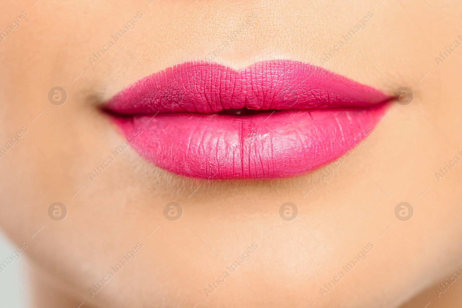 Photo of Young woman wearing beautiful lipstick, closeup view