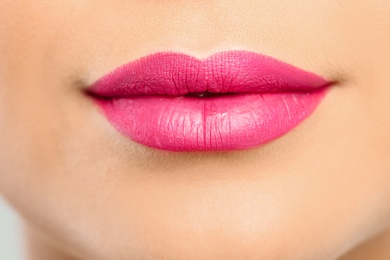 Photo of Young woman wearing beautiful lipstick, closeup view