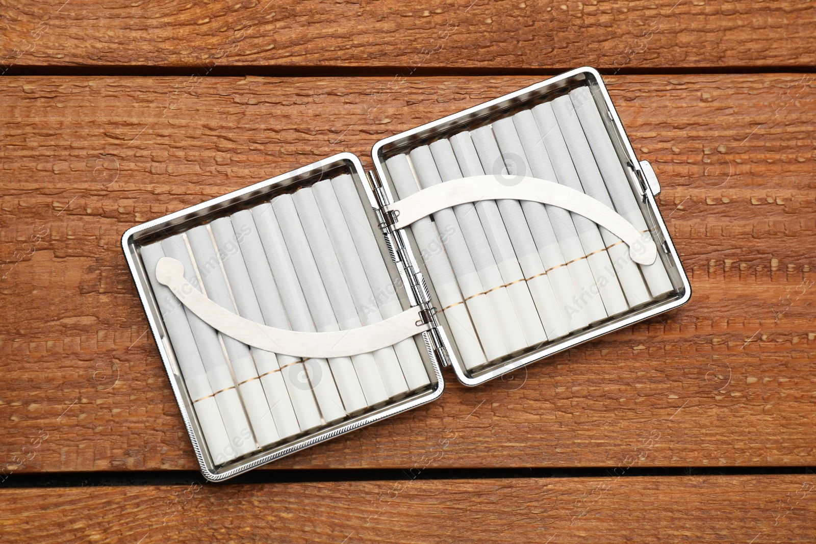 Photo of Stylish case with cigarettes on wooden table, top view