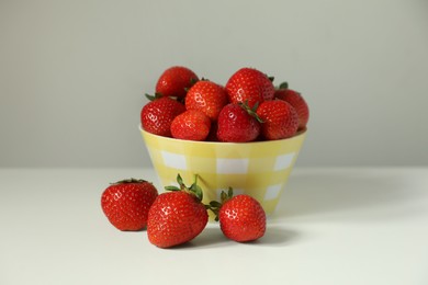 Fresh ripe juicy strawberries on white table