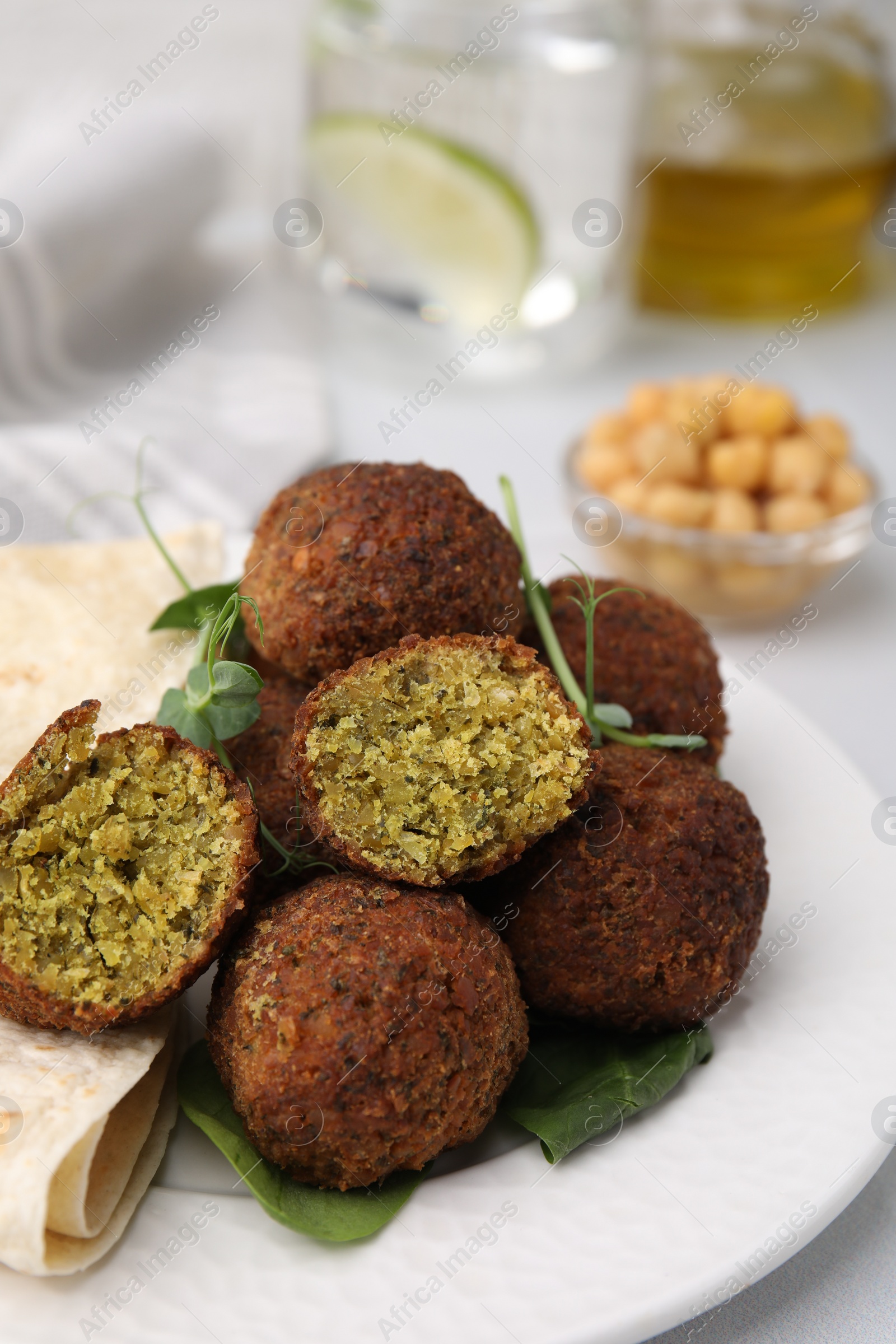 Photo of Delicious falafel balls and lavash on table