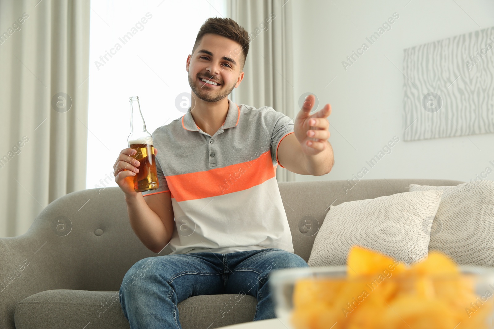 Photo of Man drinking beer while having online video conference at home, view from web camera. Social distancing during coronavirus pandemic