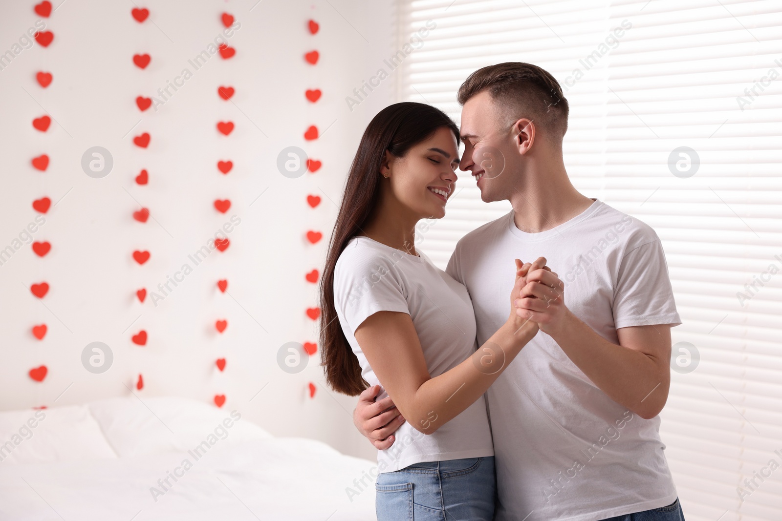 Photo of Lovely couple spending time together at home, space for text. Valentine`s day celebration