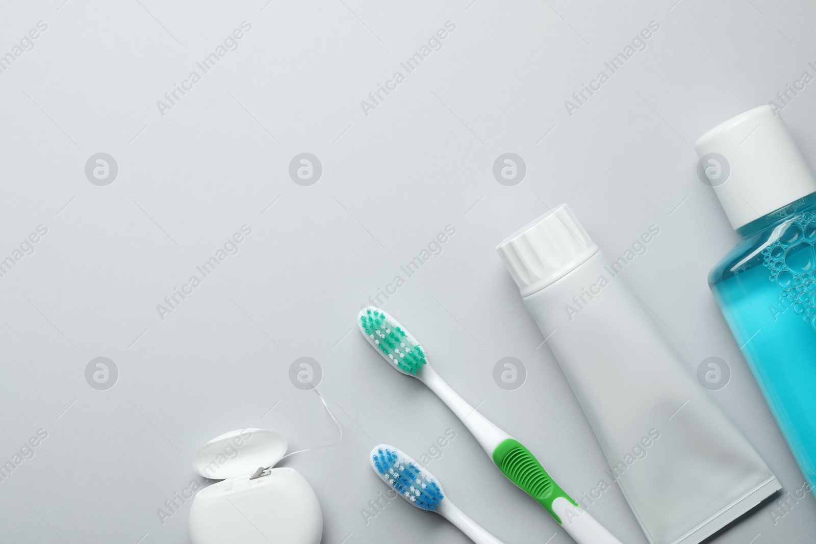 Photo of Flat lay composition with toothpaste, oral hygiene products and space for text on white background