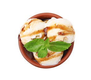 Photo of Tasty ice cream with caramel sauce, mint and nuts in bowl isolated on white, top view