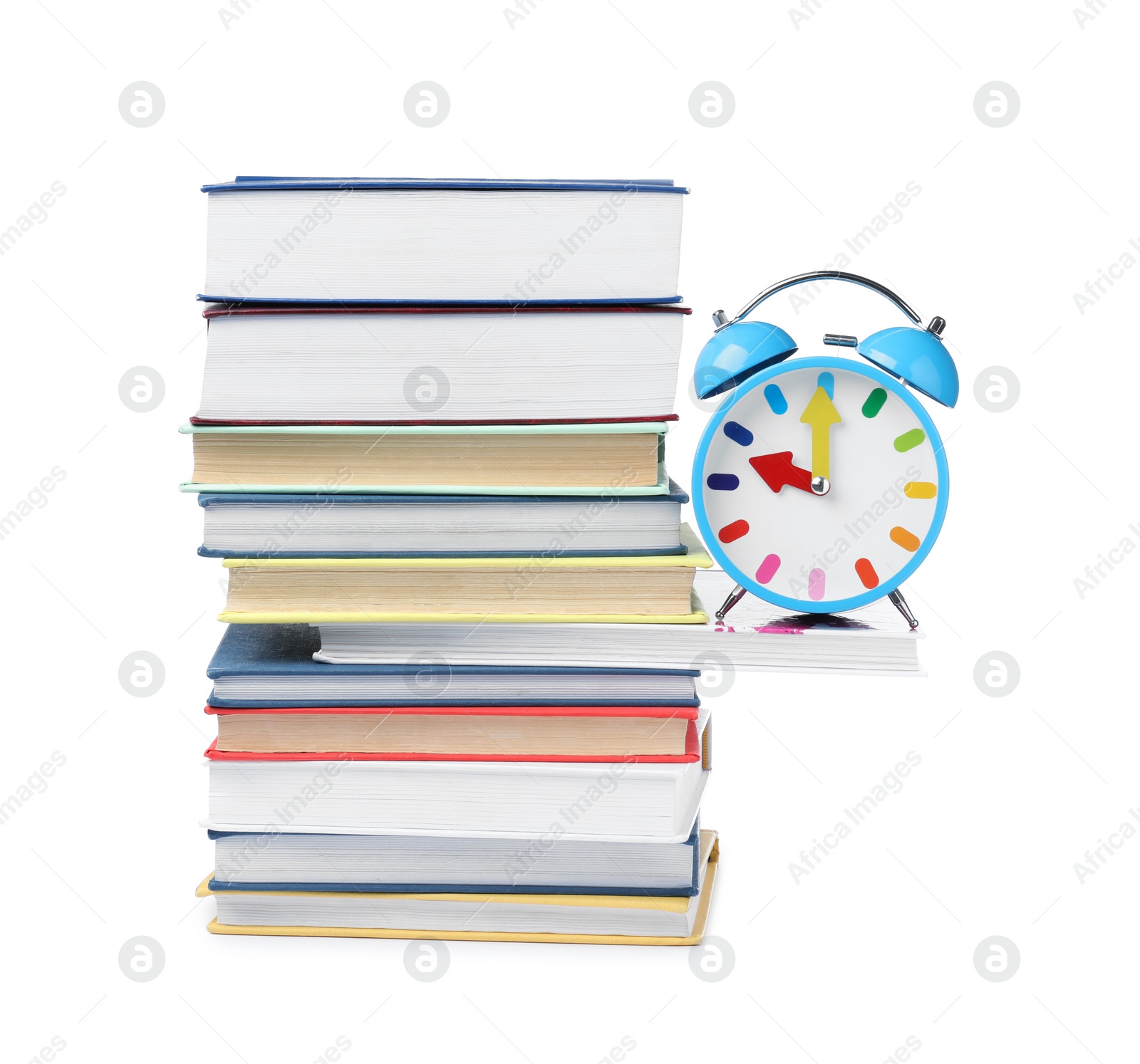 Photo of Light blue alarm clock and different books on white background. School time