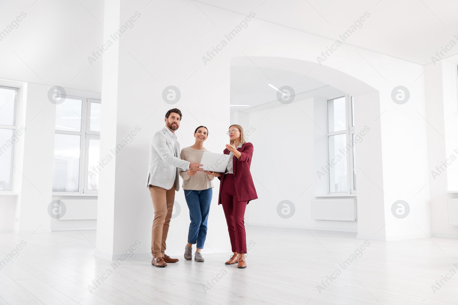 Photo of Real estate agent showing new apartment to couple