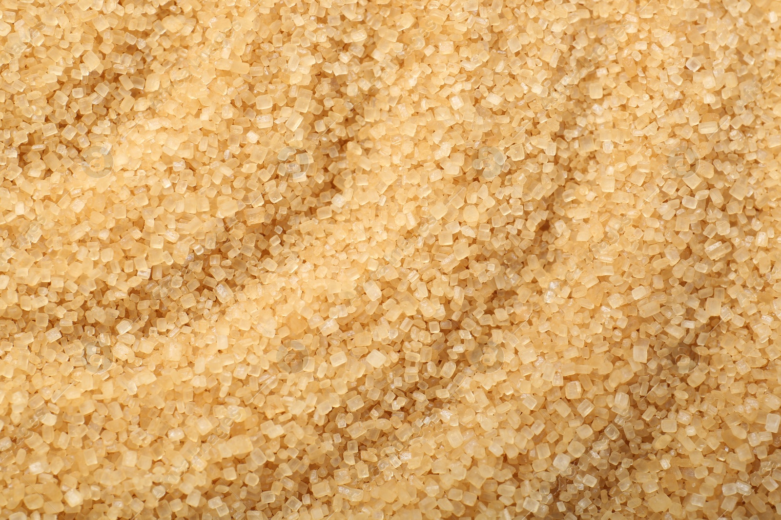 Photo of Granulated brown sugar as background, top view