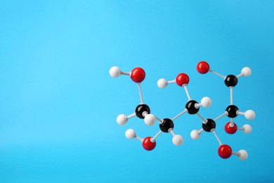 Photo of Molecule of glucose on light blue background, space for text. Chemical model