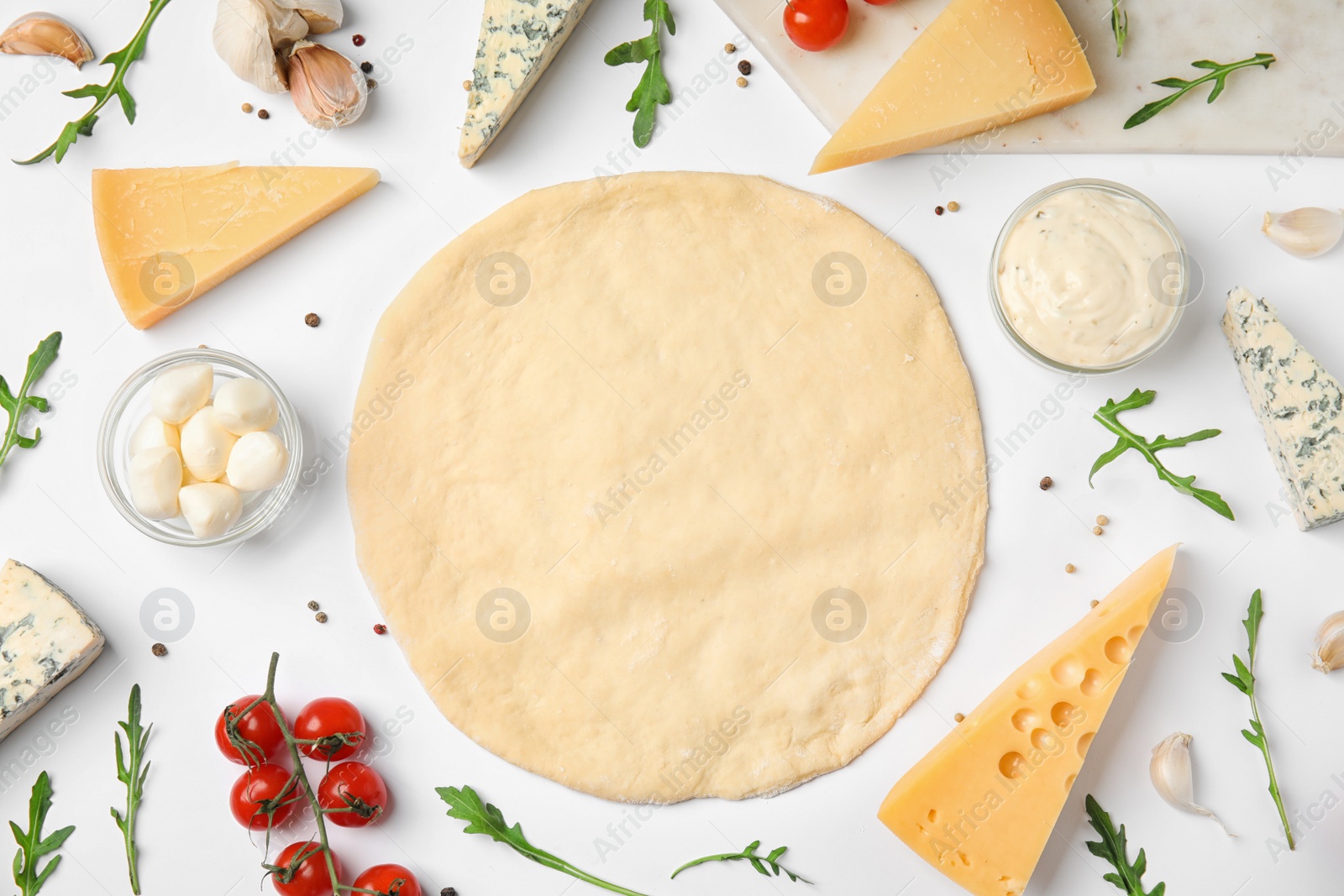 Photo of Flat lay composition with dough and fresh ingredients for pizza on white background