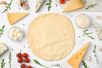Photo of Flat lay composition with dough and fresh ingredients for pizza on white background