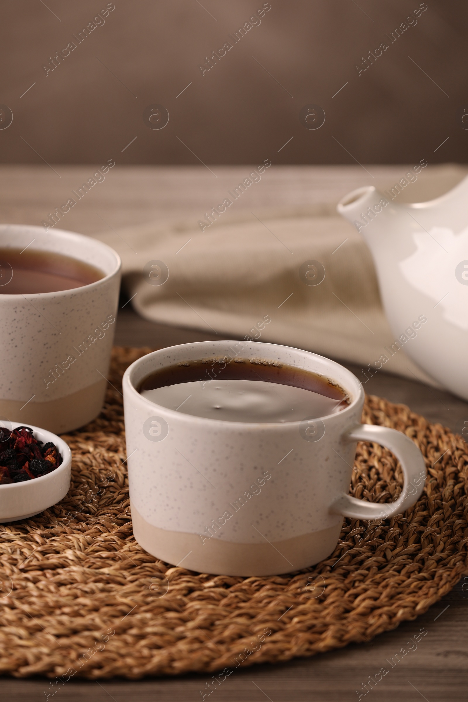 Photo of Aromatic tea and dry flower petals on wooden table