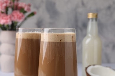 Delicious coffee with coconut syrup in glasses, closeup