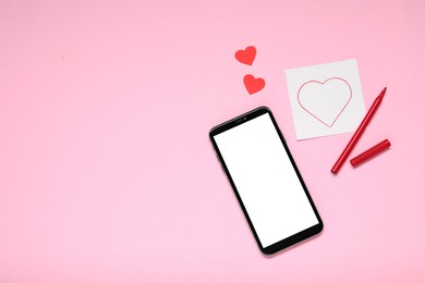 Photo of Long-distance relationship concept. Smartphone, love note, paper hearts and marker on pink background, flat lay with space for text
