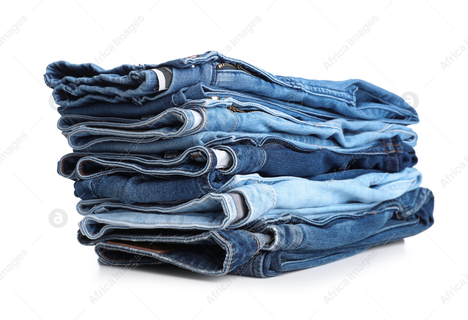 Photo of Stack of stylish jeans on white background