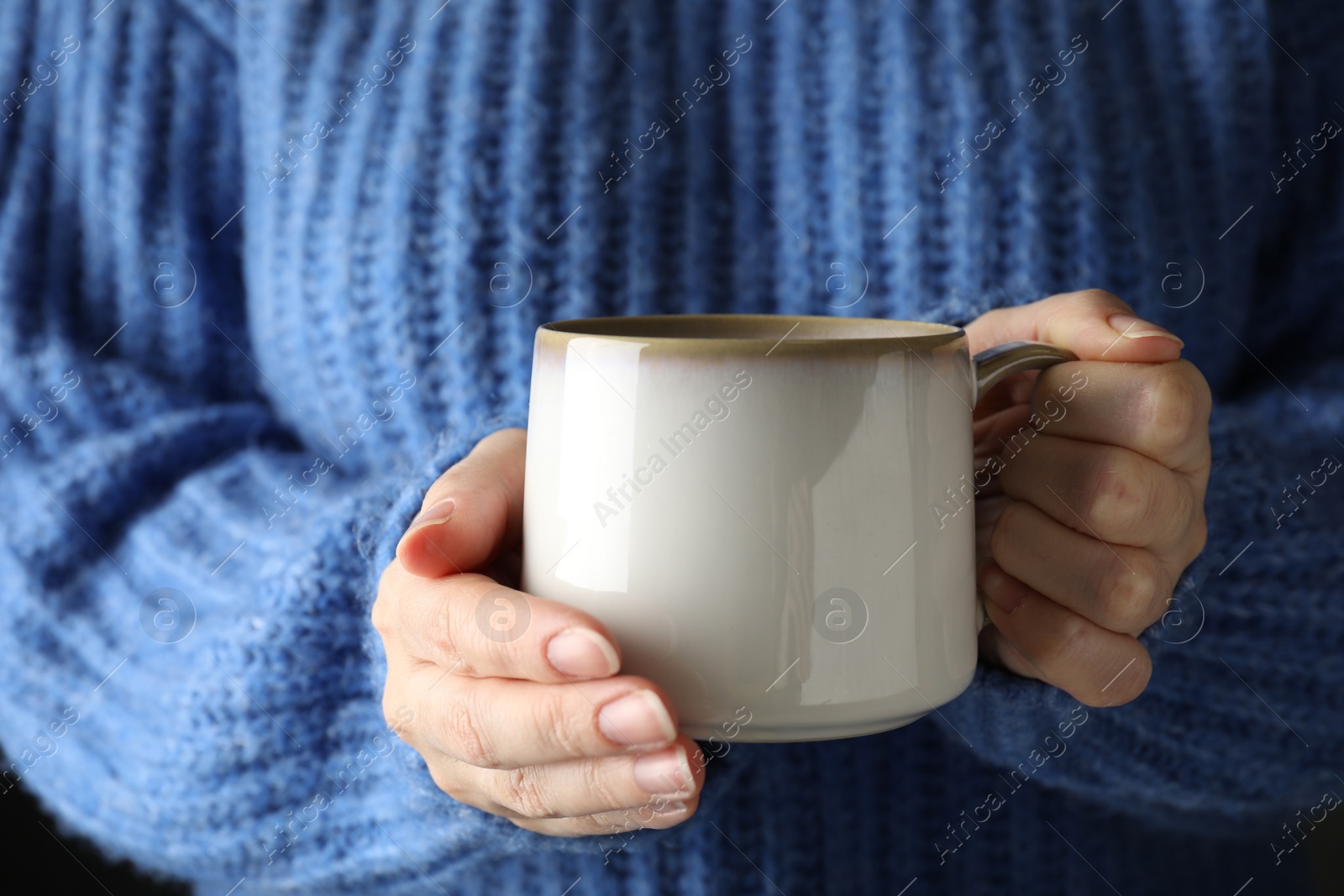 Photo of Woman holding cup of hot winter drink, closeup